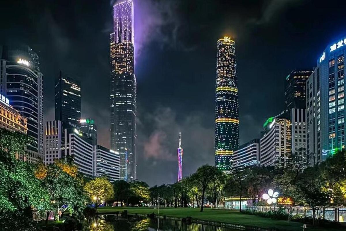 a city lit up at night with tall buildings