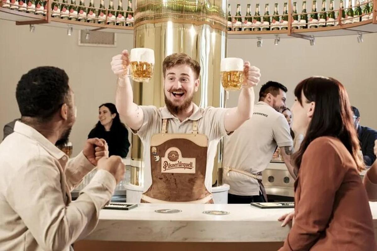 a man holding up two glasses of beer
