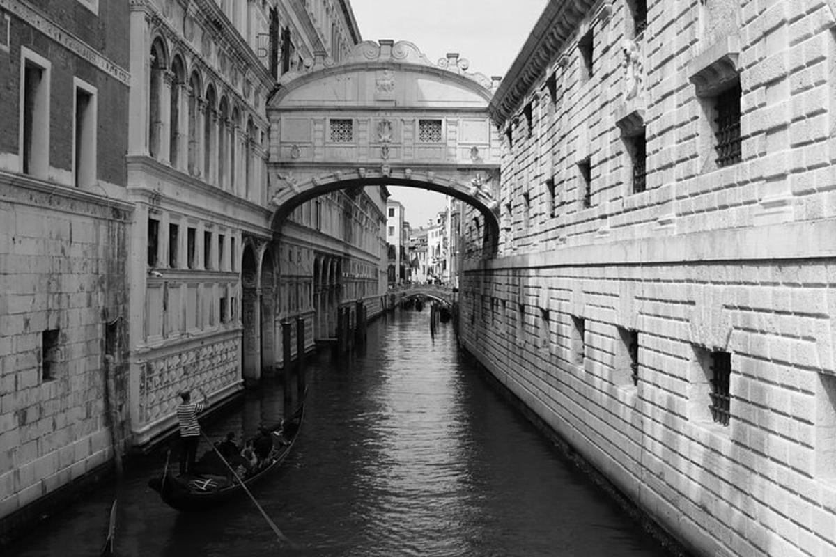 a bridge over a canal between two buildings