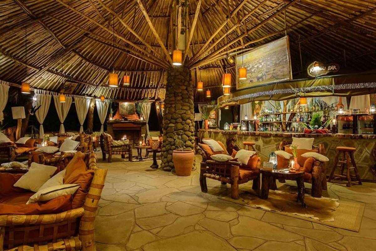 a large room with a bar with couches and chairs