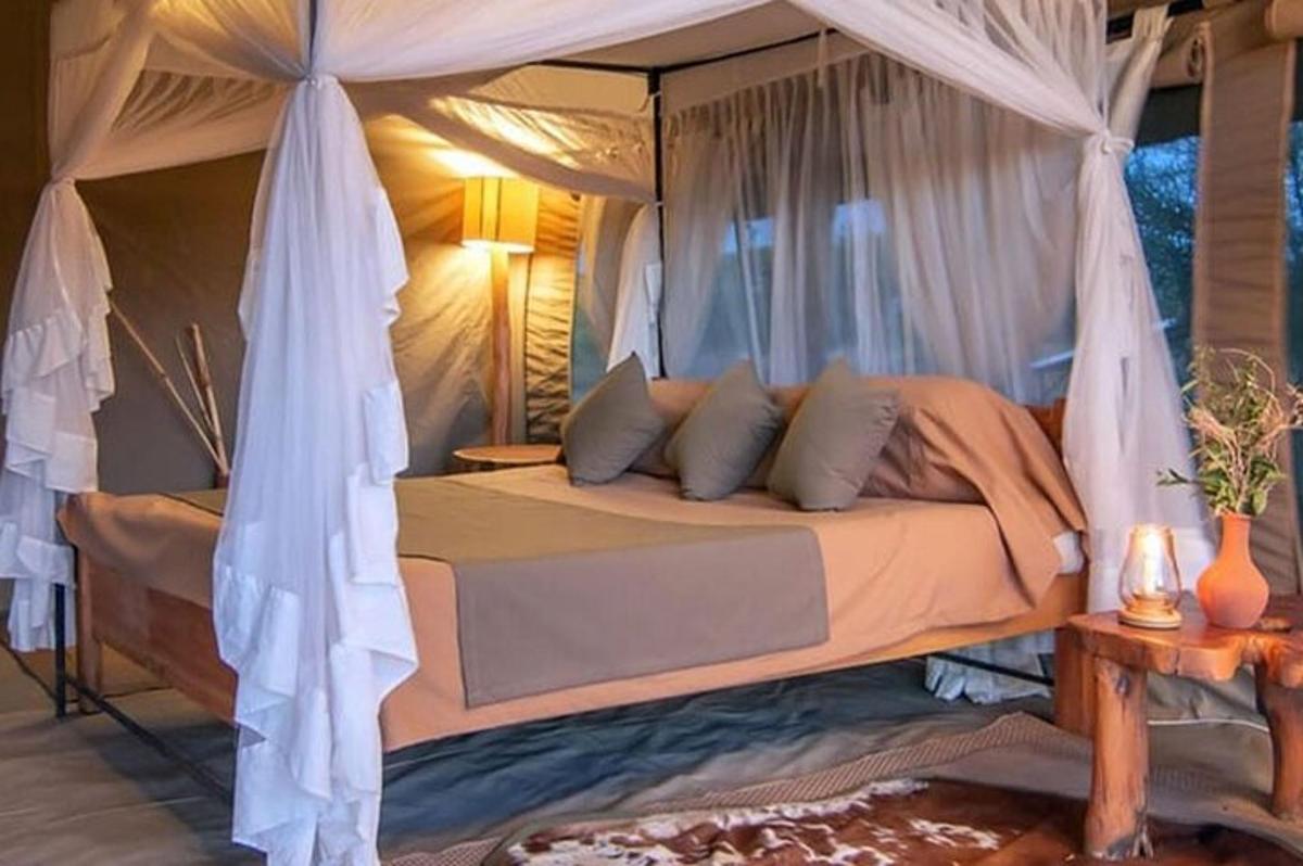 a bedroom with a bed with a canopy