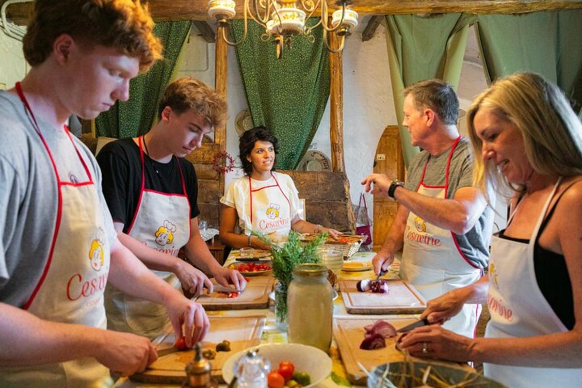 a group of people standing around a table preparing food