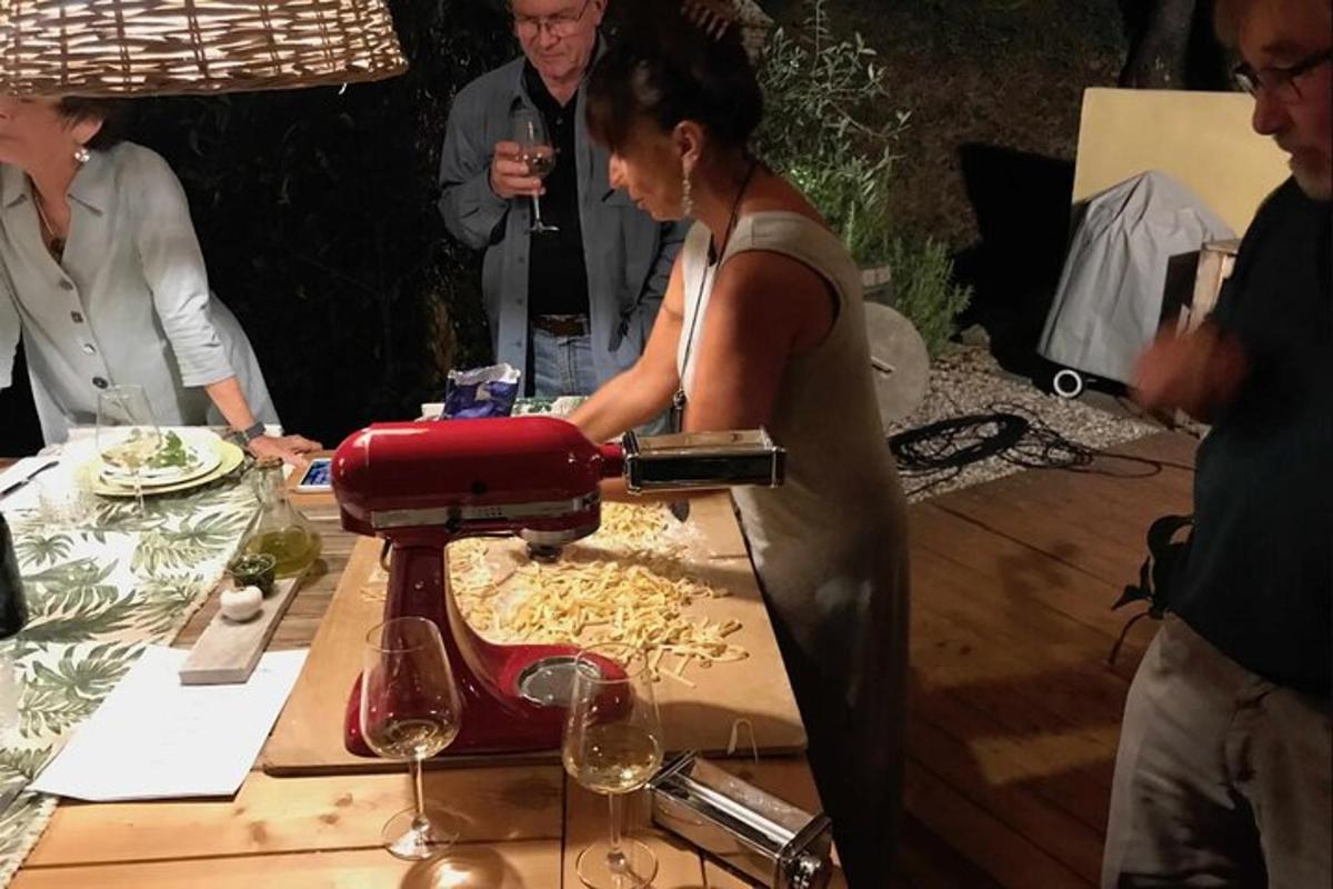 a woman is pouring wine into a red wine