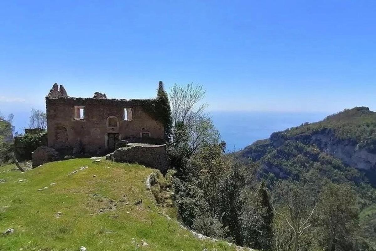 an old house on the side of a hill