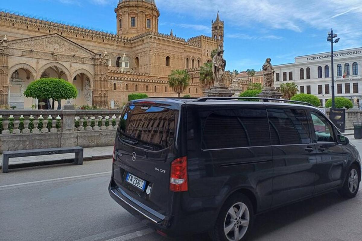 a black minivan parked in front of a building