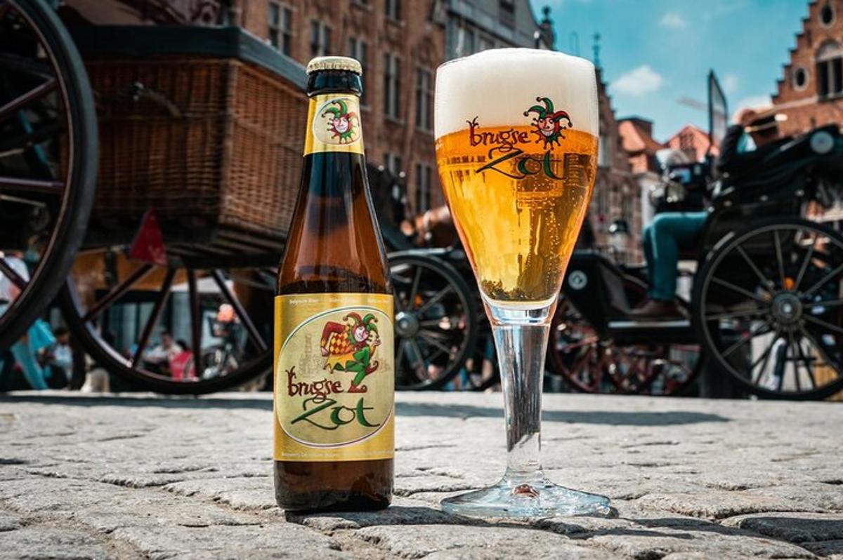 a bottle of beer sitting next to a glass