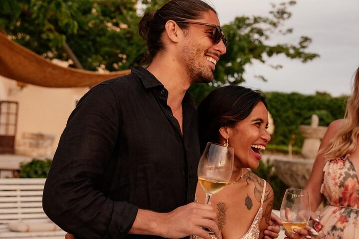 a man and a woman holding a glass of wine