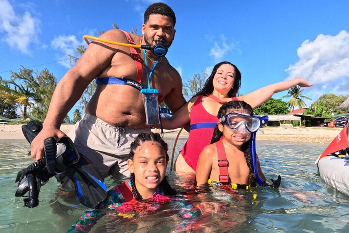 a family standing in the water at the beach
