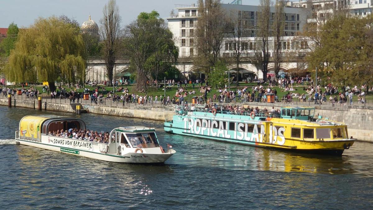 two boats in the water with people on them