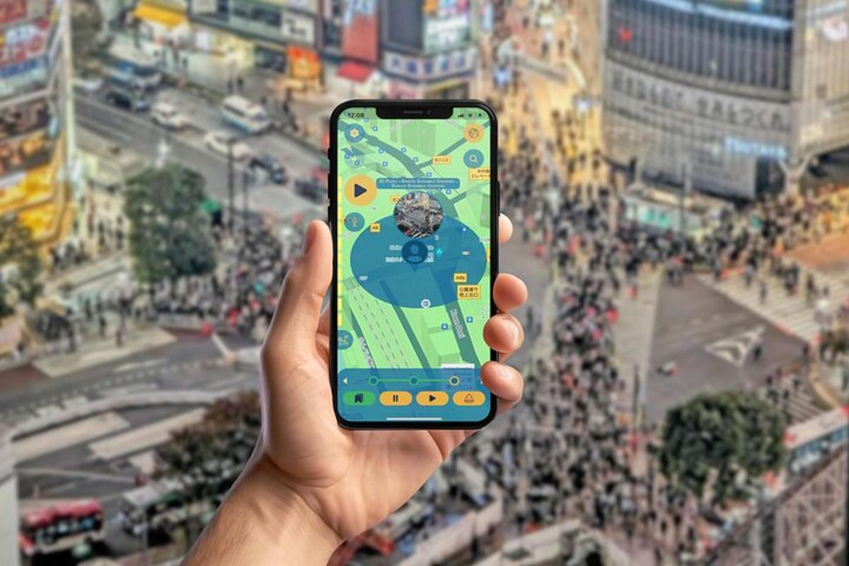 Una persona sosteniendo un teléfono celular en una ciudad.