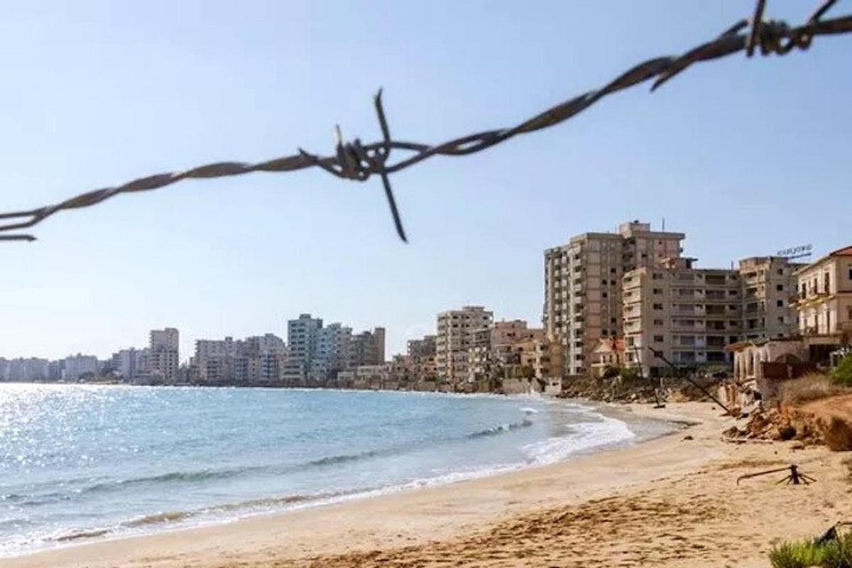 a view of a beach with buildings and the ocean