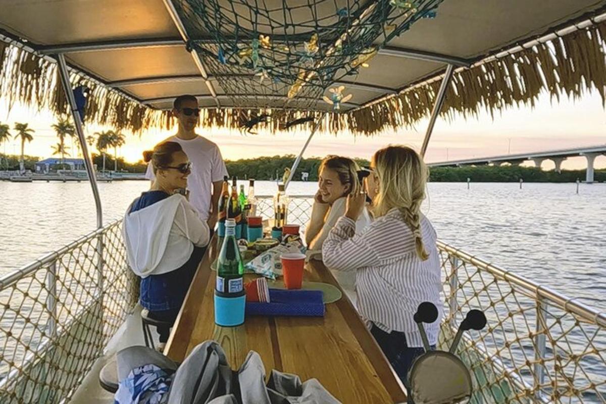 a group of people sitting at a table on a boat