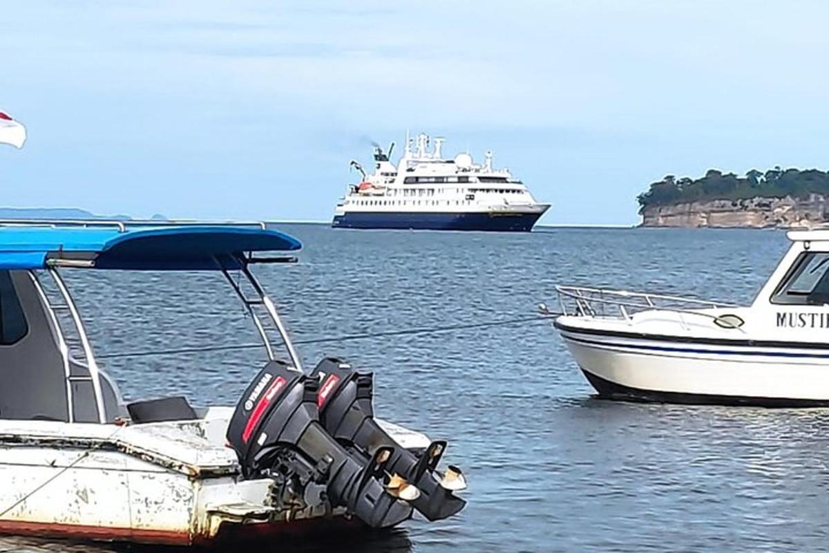two boats in a body of water with two ships
