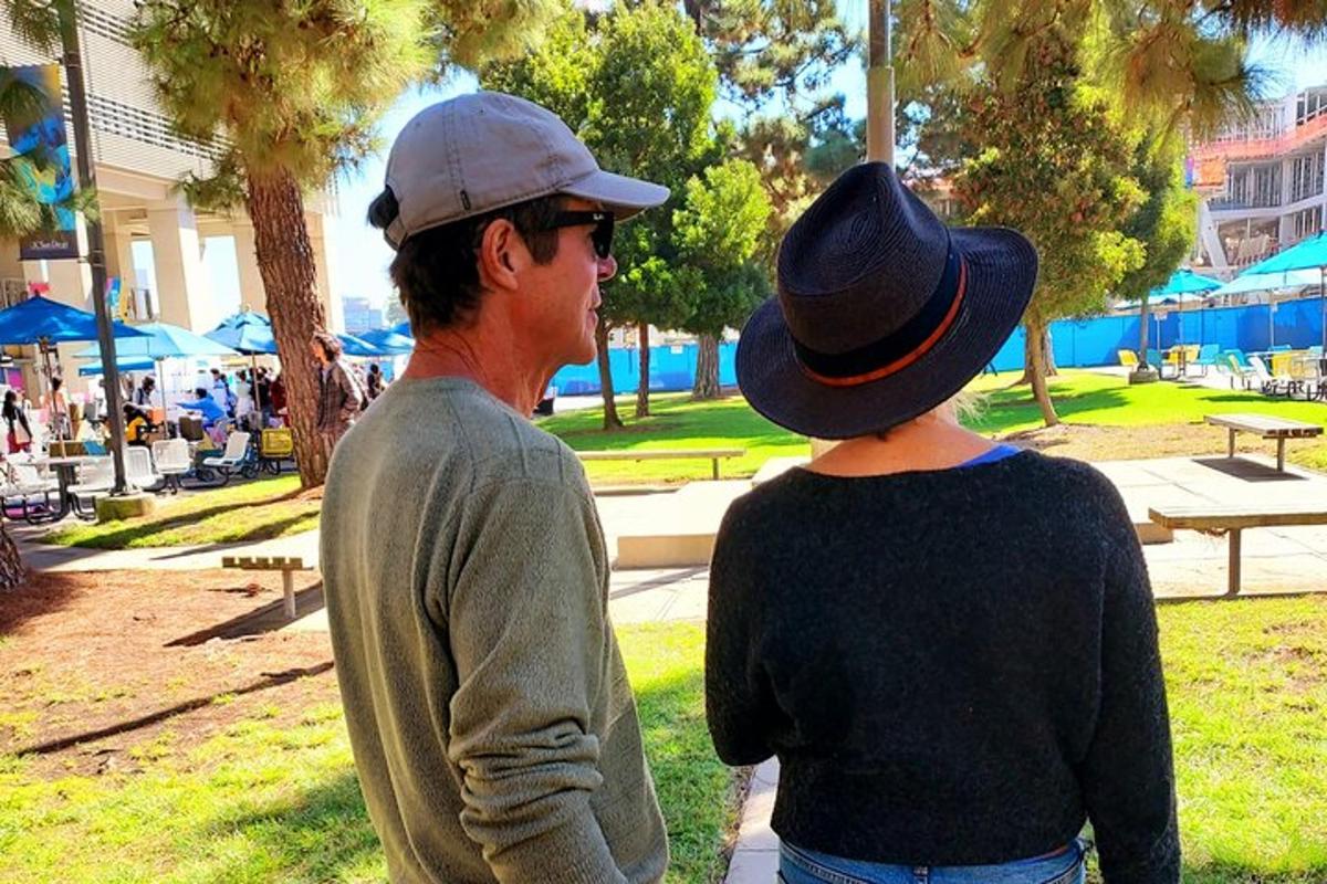 a man and a woman standing in a park
