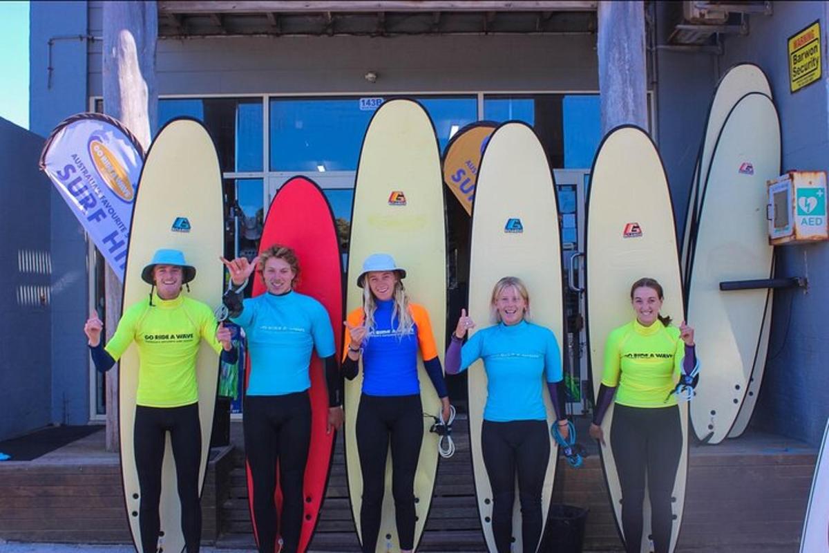 a group of people standing in front of surfboards