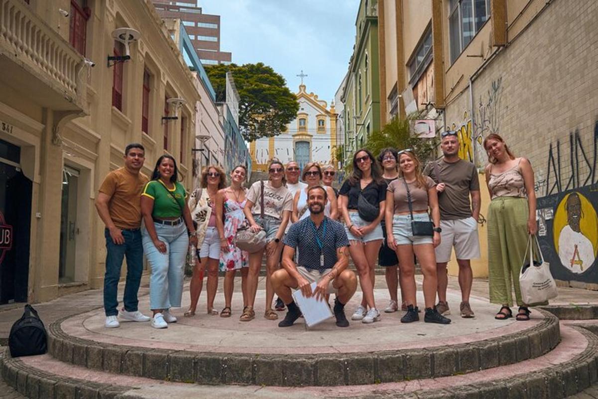 a group of people posing for a picture on a street