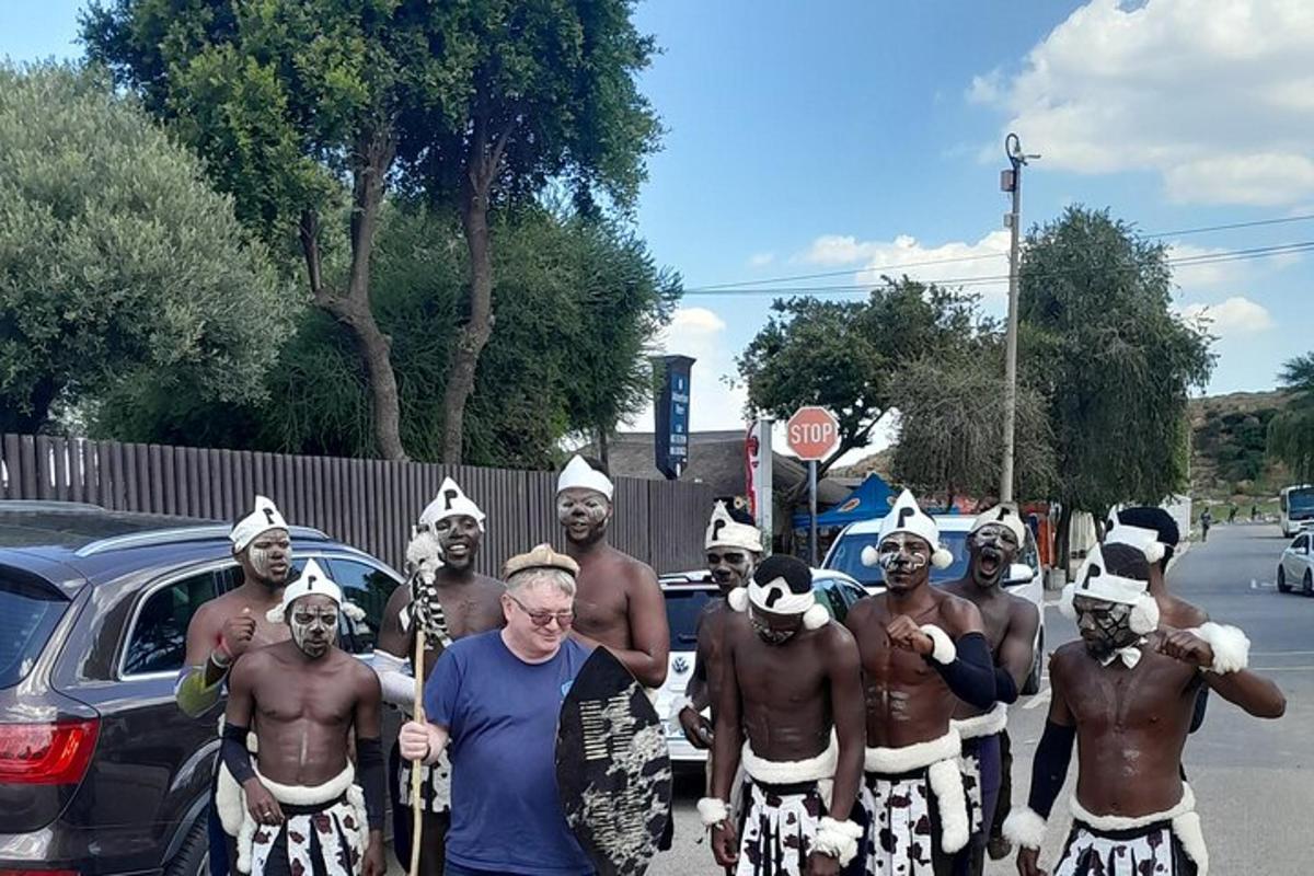 mees seisab kostüümides meesterühma ees