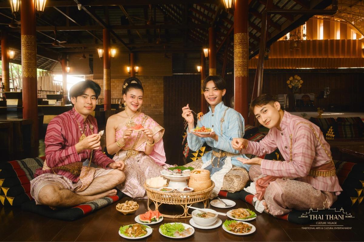 a group of people sitting around a table eating food