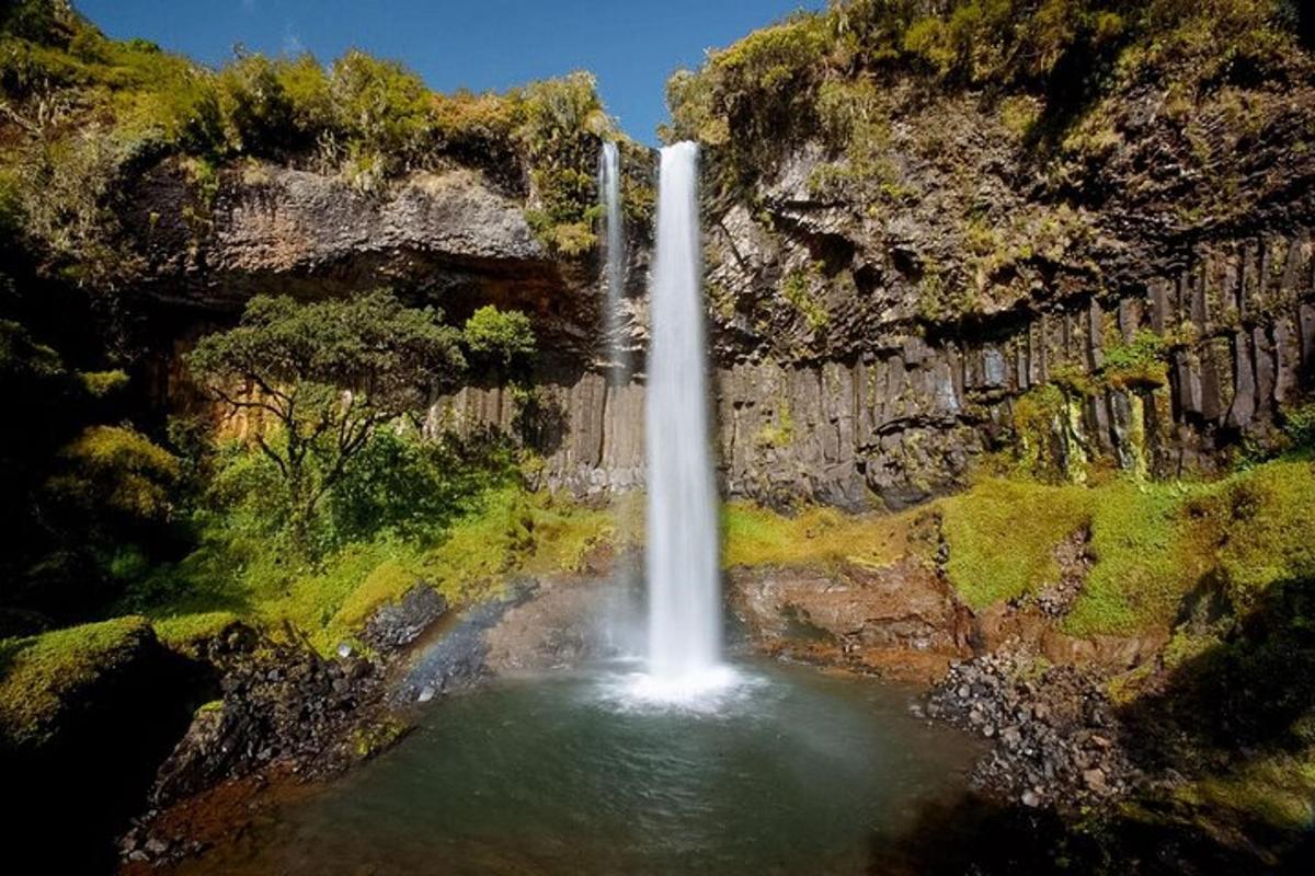 a waterfall in the middle of a pool of water