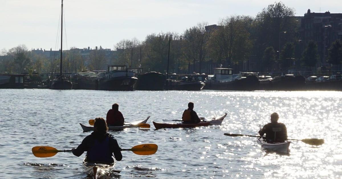 a group of people in kayaks on a body of water