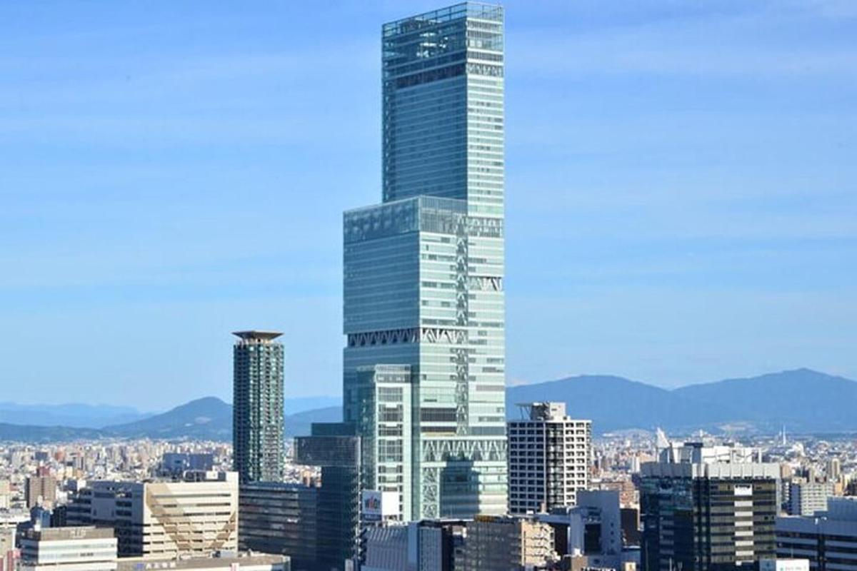 a view of a city with a tall skyscraper