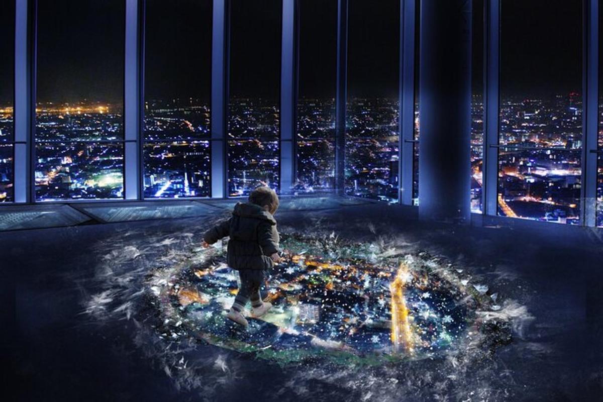 a young boy standing on top of a building with a city