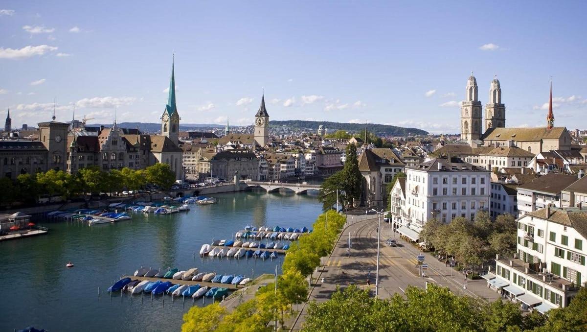 a view of a city with boats in a river