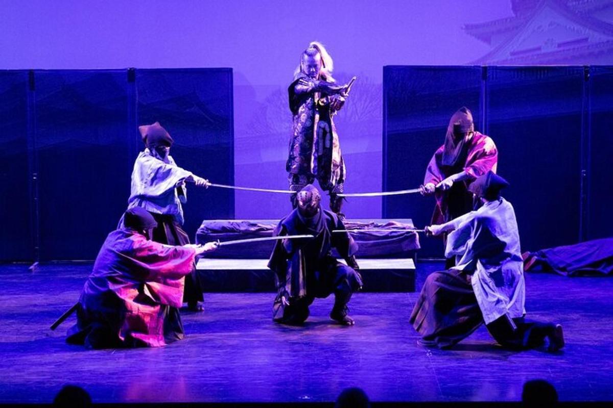 a group of people pulling a rope on a stage