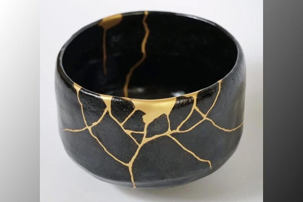 a black and gold bowl sitting on a table