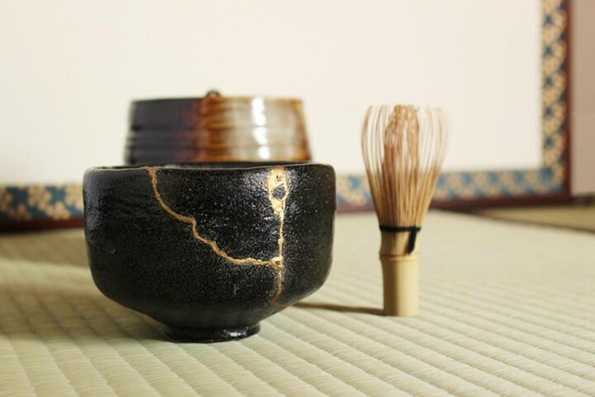 a black cup and a wooden brush on a table