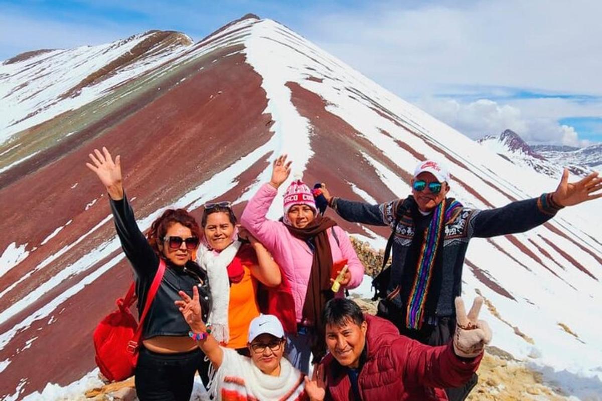 a group of people posing in front of a mountain
