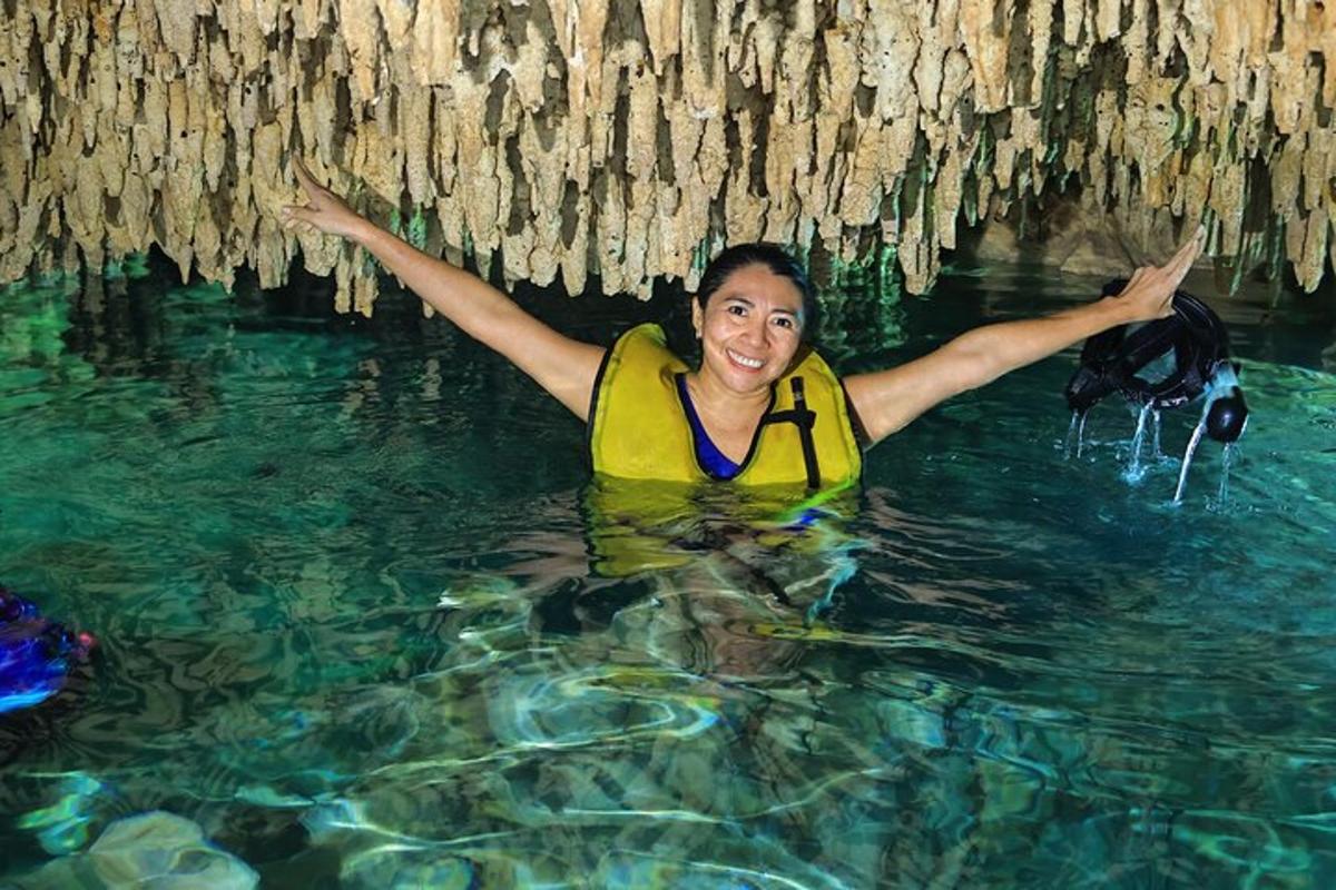 a woman in the water in a cave