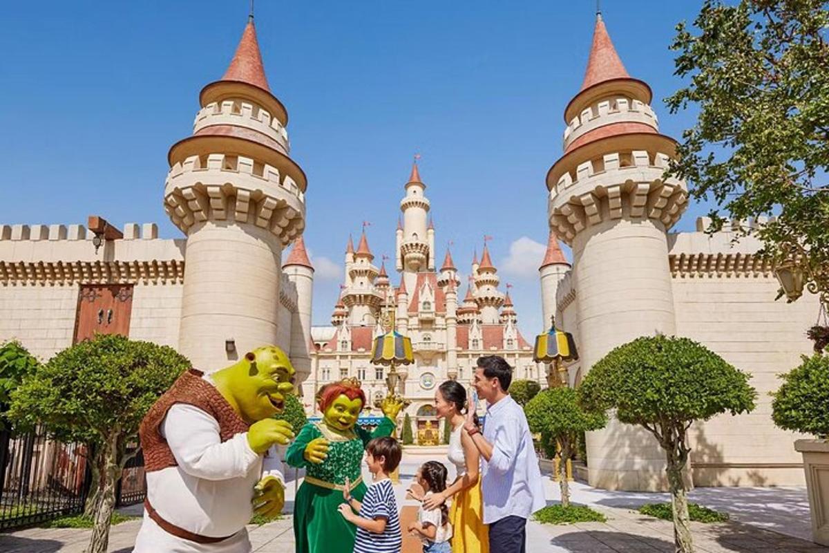 a group of people standing in front of a disney castle