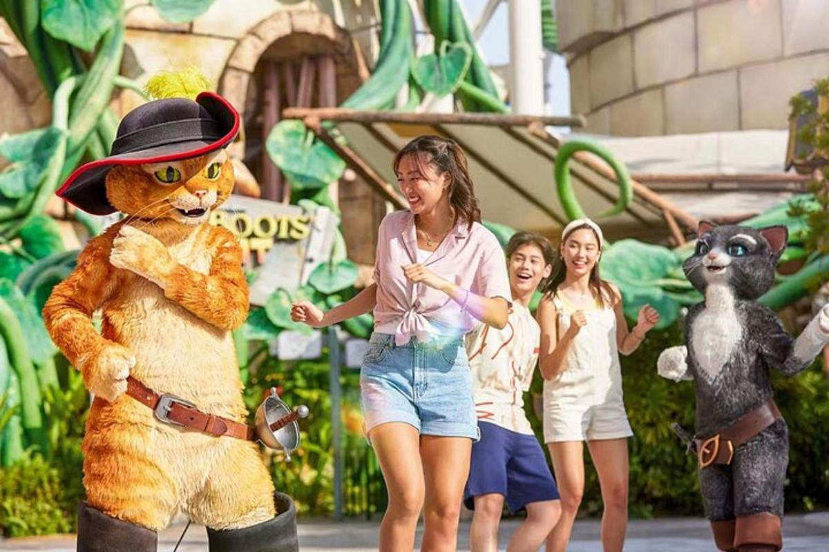 a woman standing next to a girl standing next to a tiger mascot