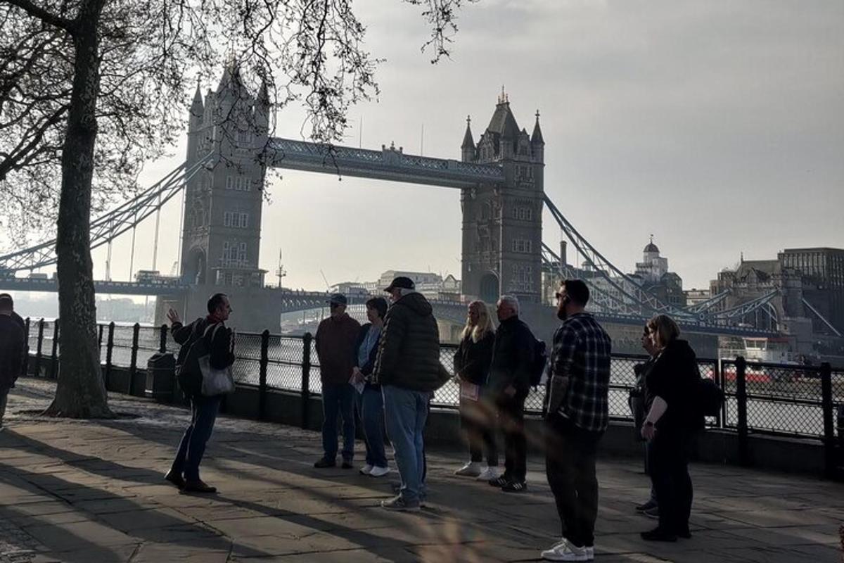 a group of people standing in front of the tower bridge