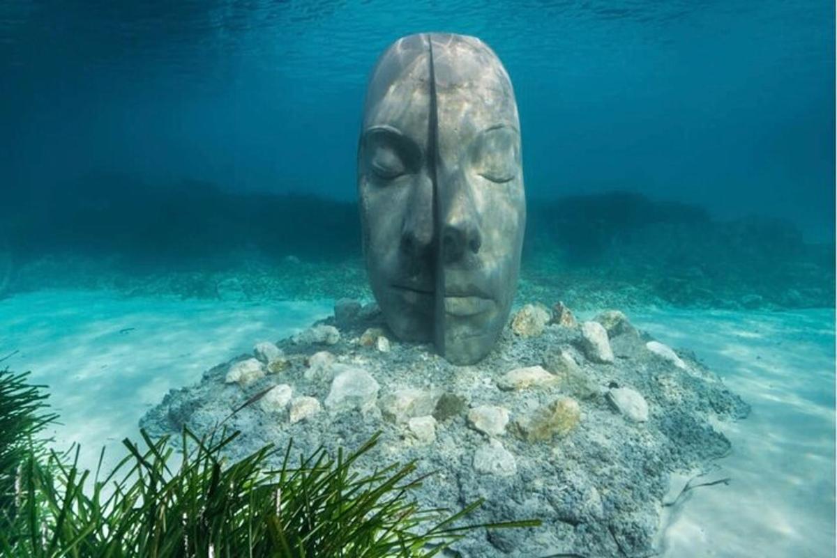 a statue of a head in the water
