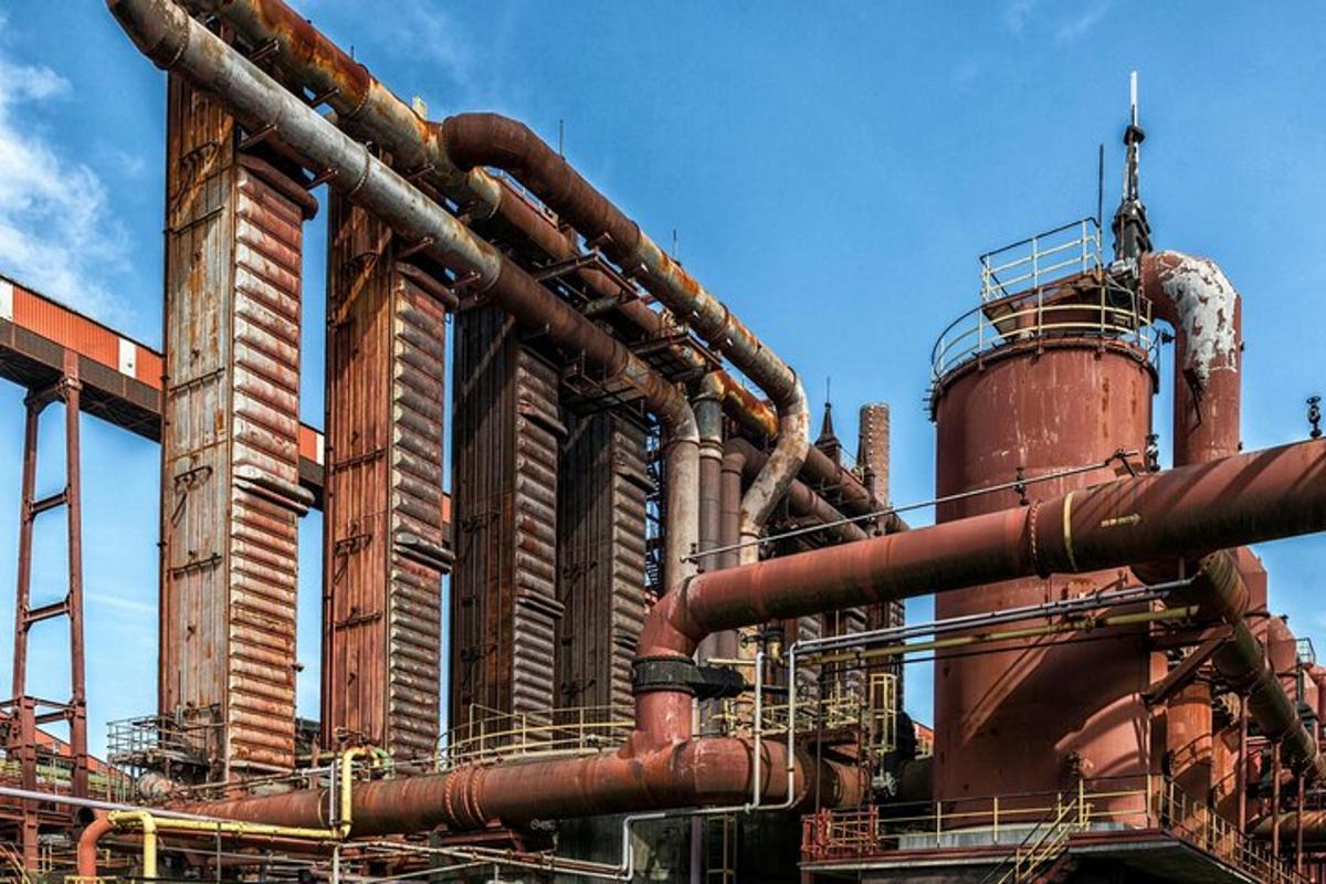 a large factory with many pipes and a tower