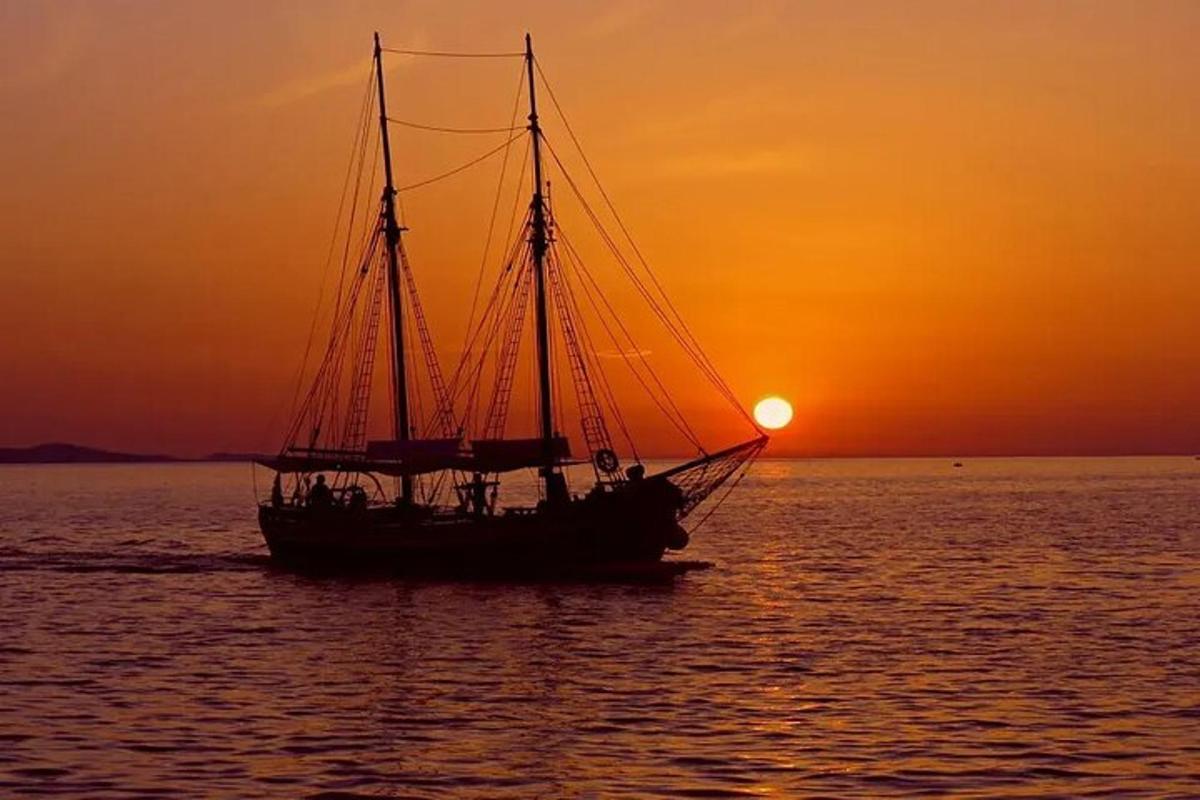 una barca in acqua con il tramonto sullo sfondo