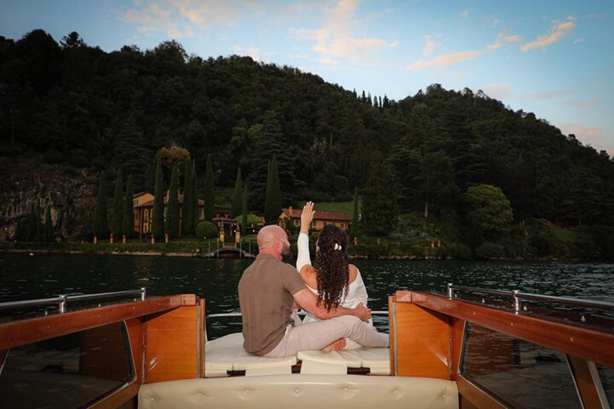 a man and woman sitting on the back of a boat