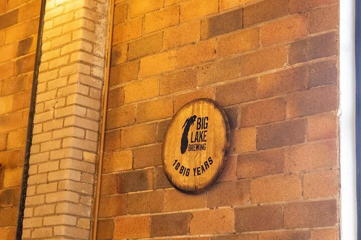 a wooden sign on the side of a brick wall