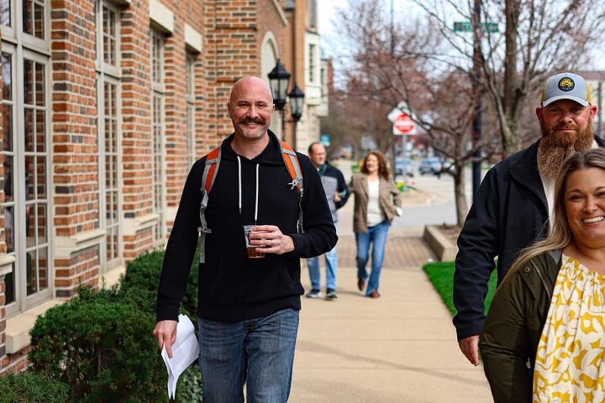 a group of people walking down a sidewalk