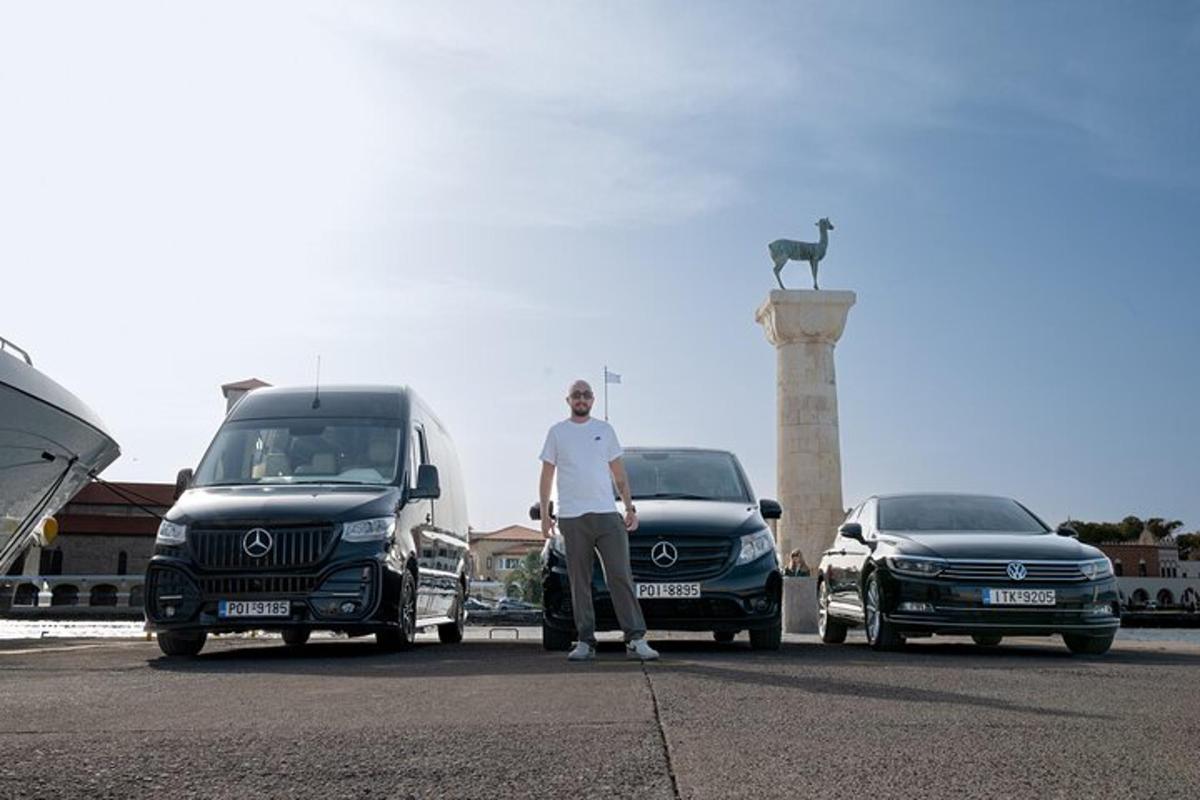 a man standing in a parking lot next to two trucks