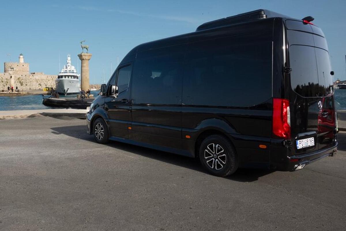 a black van parked next to the water