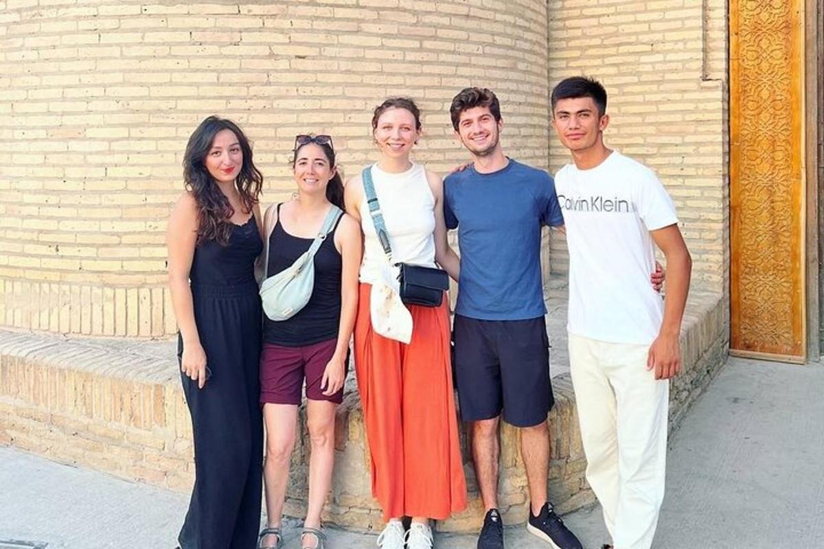 a group of people standing next to a brick wall