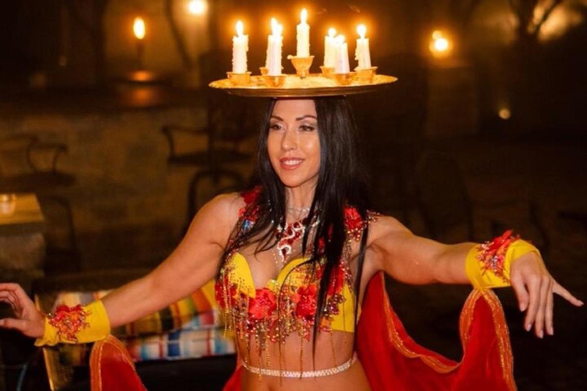 uma mulher de vestido com um bolo na cabeça