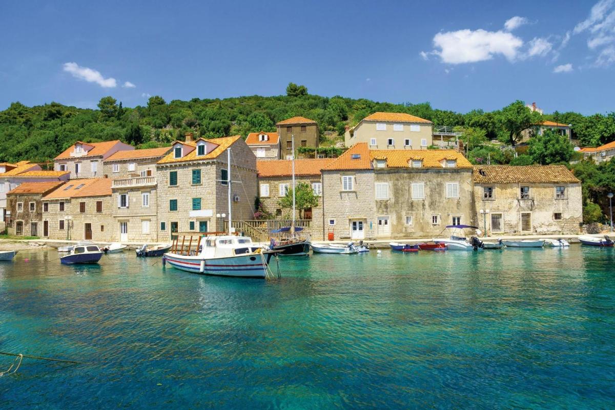 a group of boats docked in a river with buildings
