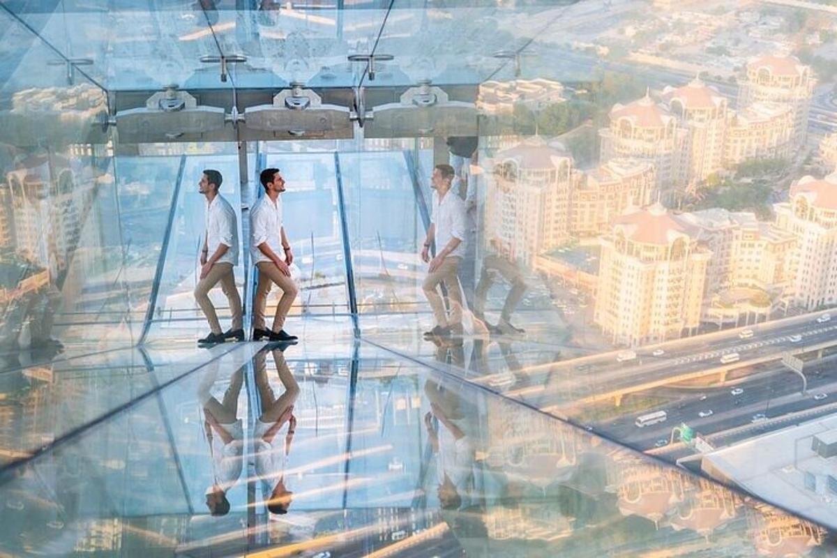a group of people walking on the glass floor of a building