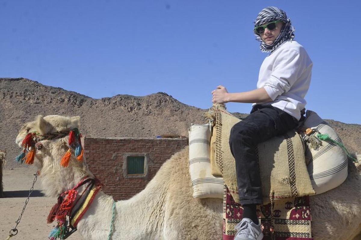 a man riding on the back of a camel