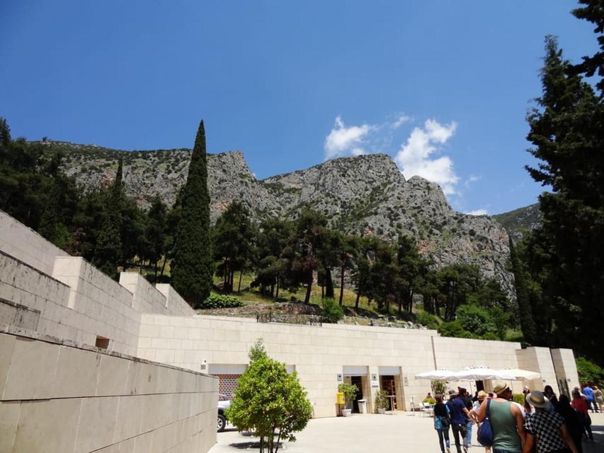 a group of people walking in front of a mountain