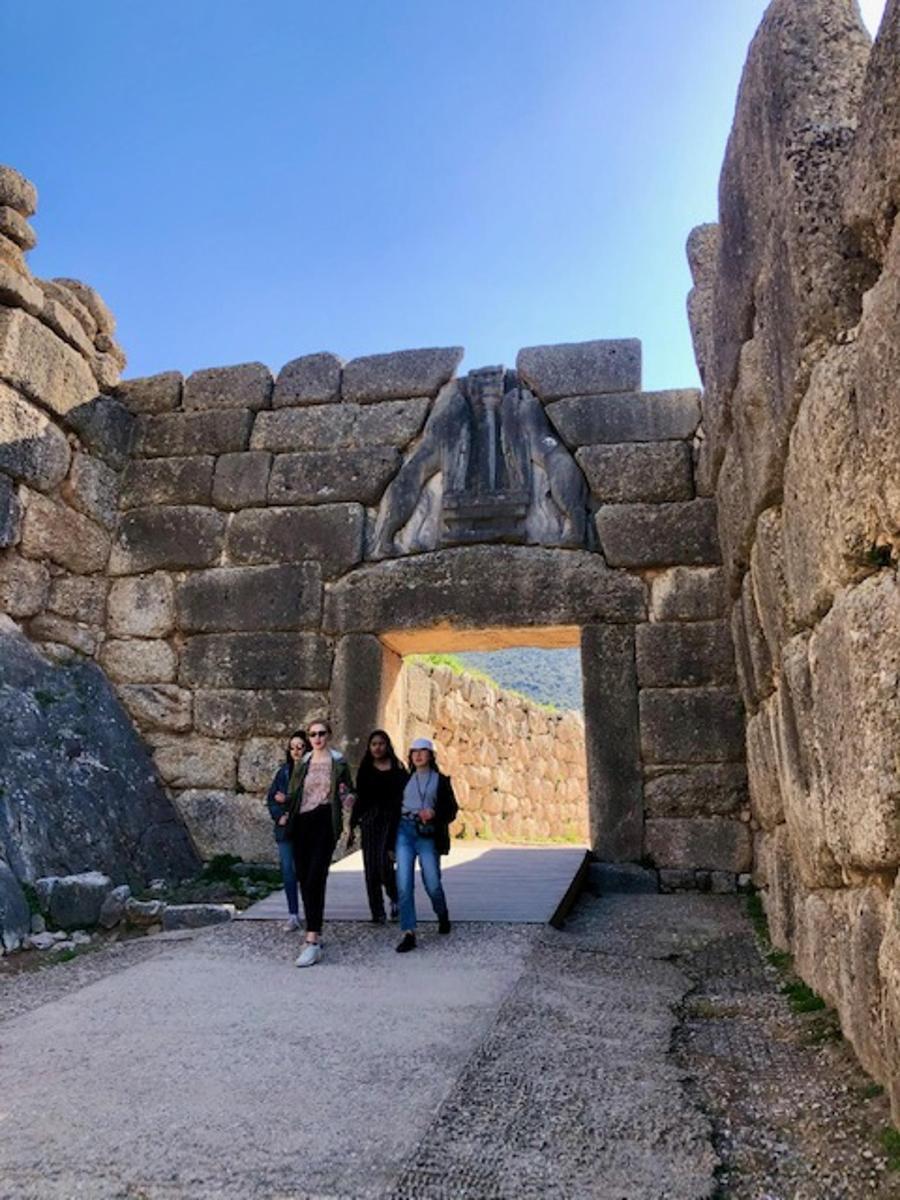 skupina lidí procházejících kamenným tunelem